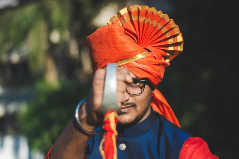 a person dressed in a colorful hat and orange scarf