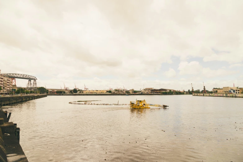 there is a yellow boat in the middle of a lake