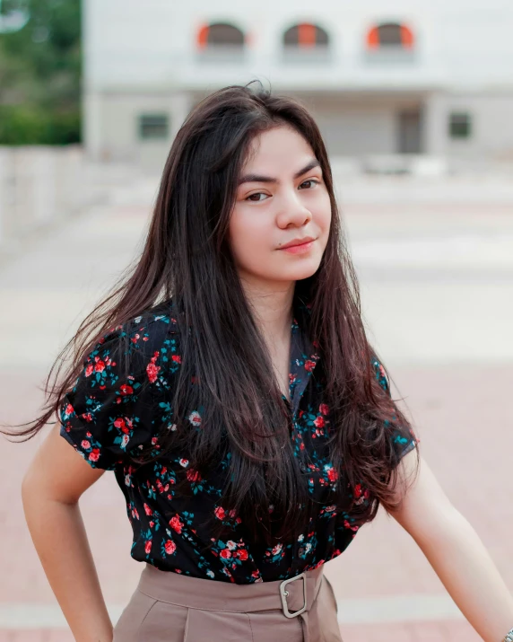 a woman wearing a dress posing with her hands on her hips