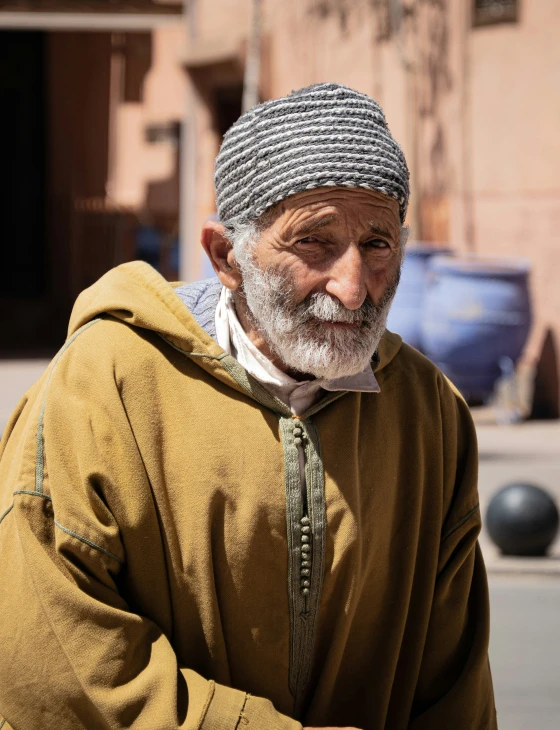 an old man in a brown hoodie is carrying soing