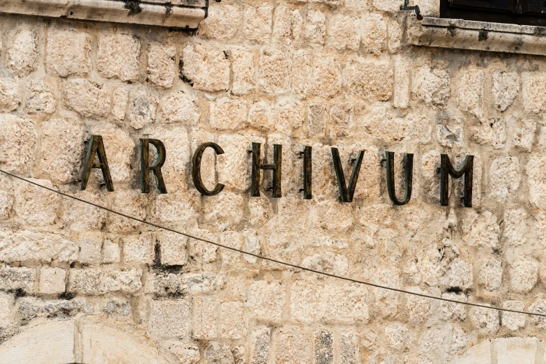 the name arthimm carved into the side of an old building