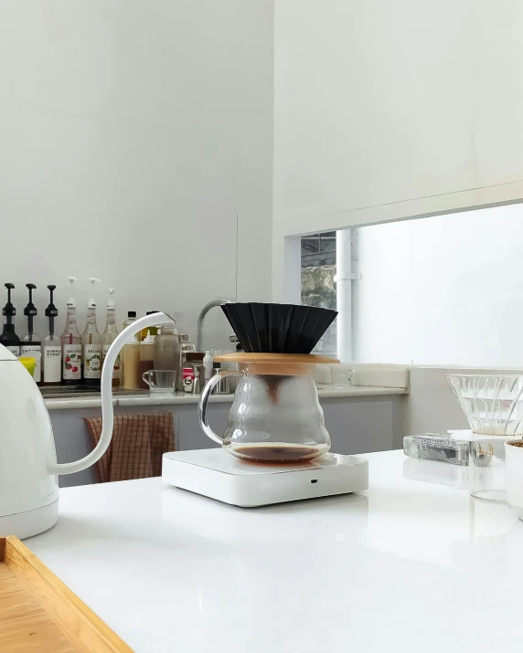 white blender sitting on a kitchen counter top with wine glasses