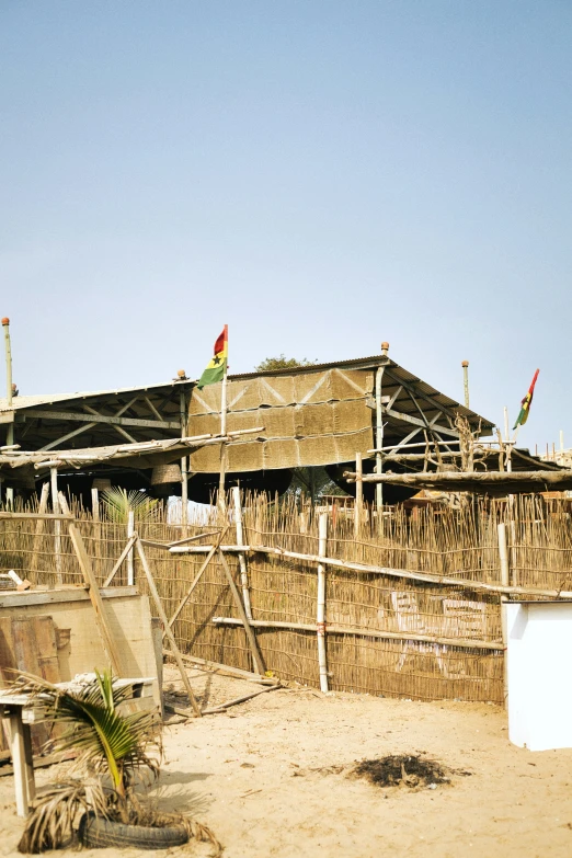 a wooden house has many wooden poles on top of it