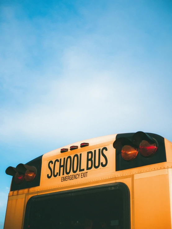 a yellow school bus with two red lights on it