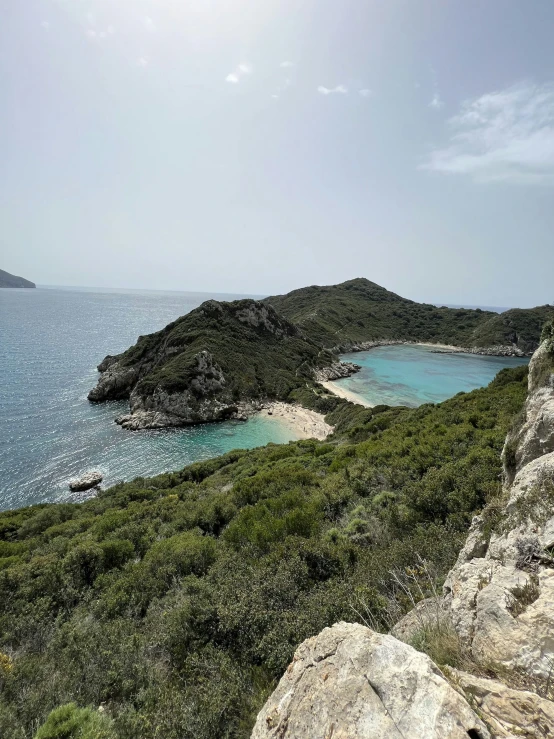 several small coves next to the water with a boat in the middle