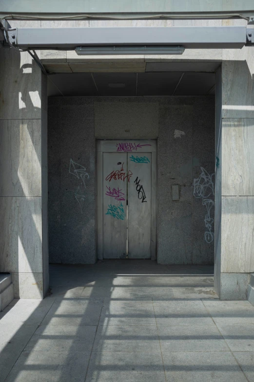 a concrete hallway with a door on both sides