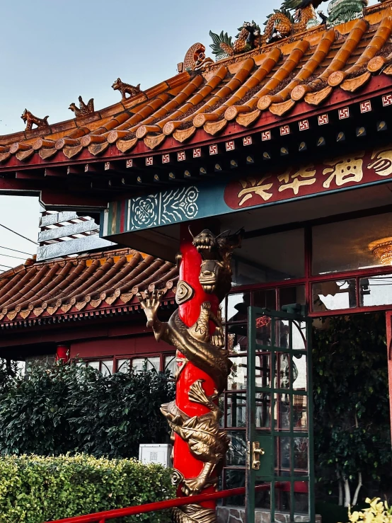 the entrance to an asian pavilion with a red door