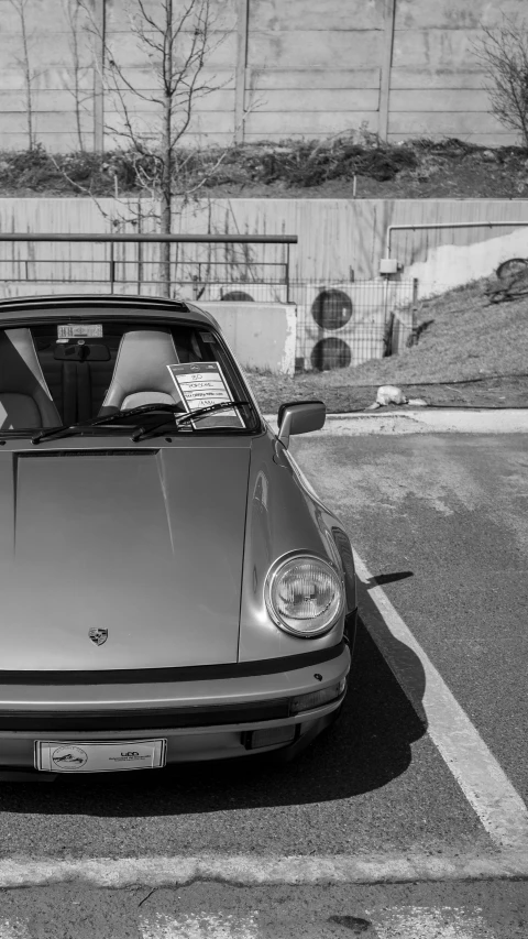 a black and white po of a woman sitting in her car