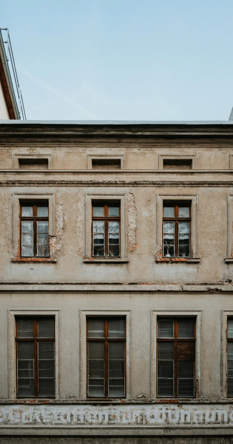 a building has broken windows and boarded doors