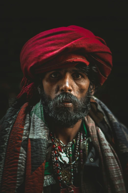 man with turban and beads and bead necklaces