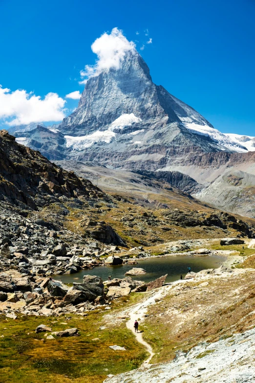 an alpine river below a rocky mountain range