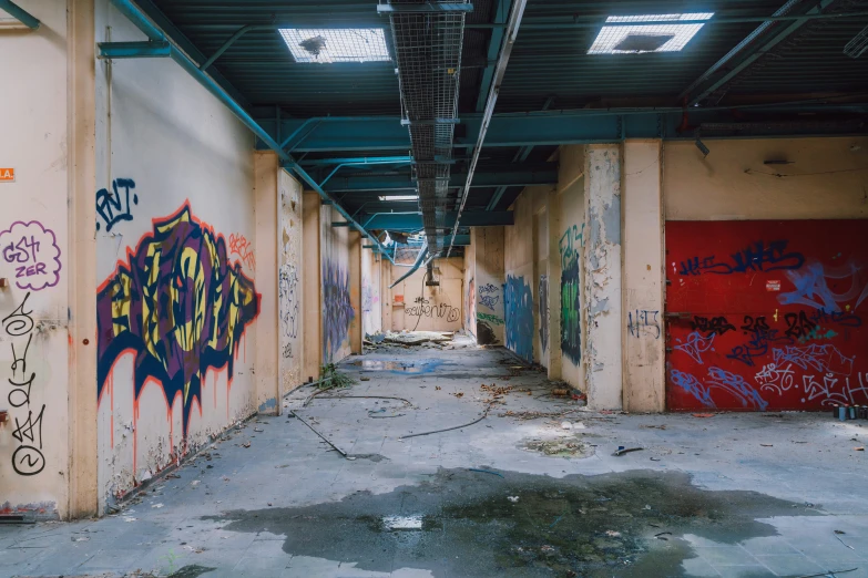 an area with graffiti on a wall and doors and ceiling