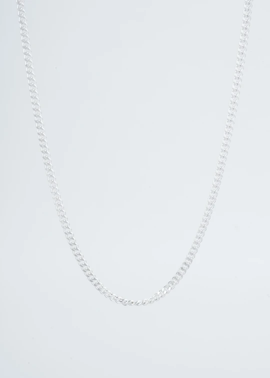 a white table with a necklace on top of it