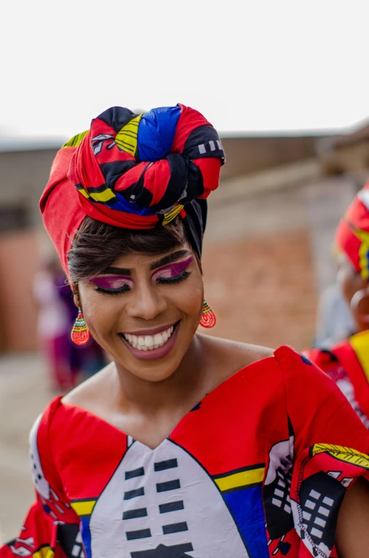 a woman in a colorful dress smiling