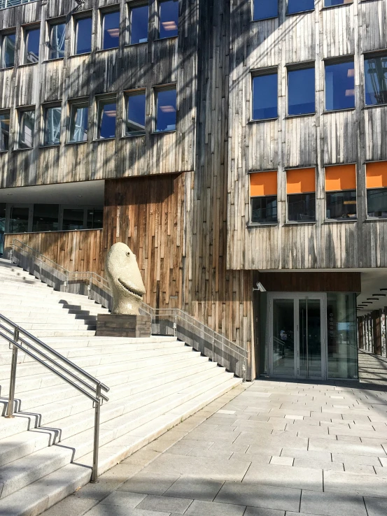 the stairs are near a building and a big glass window