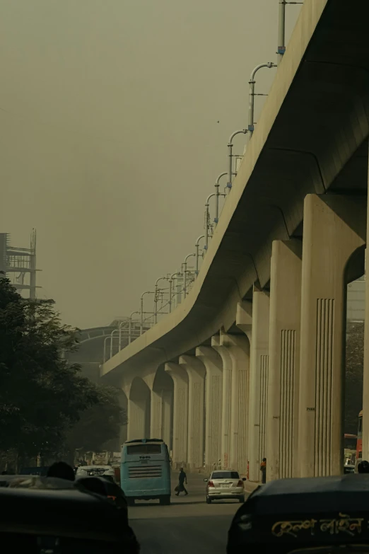 cars are driving down a freeway underneath a bridge