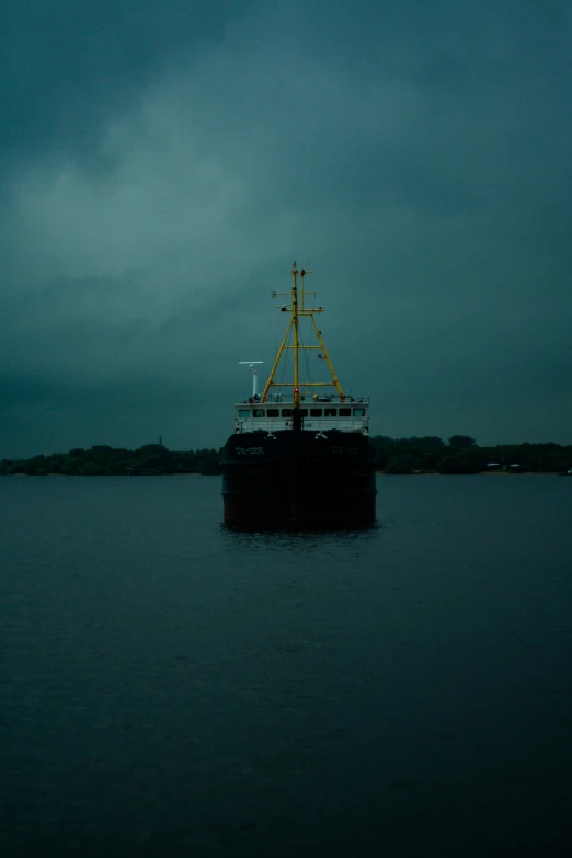 a yellow and black boat sailing on top of a body of water