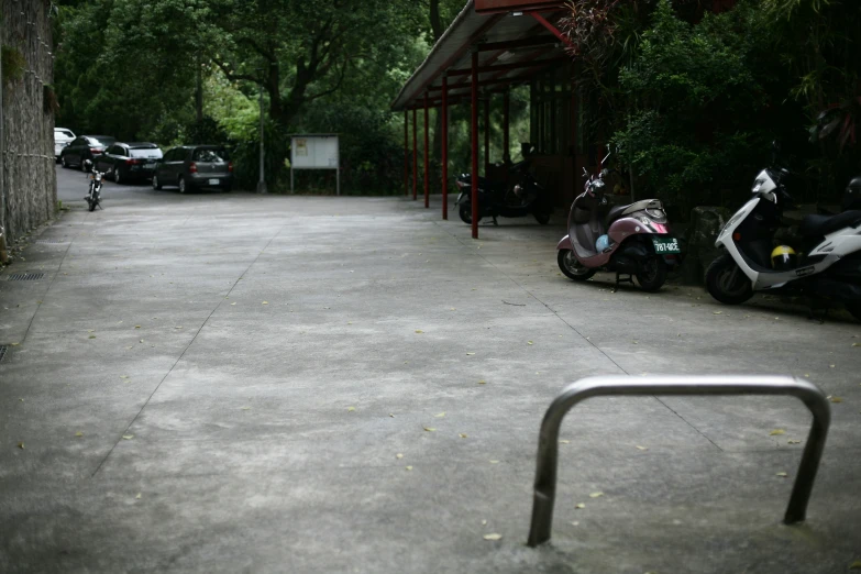 two motor scooters parked in front of a building