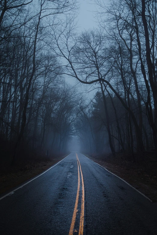 a quiet road with no cars on it at night