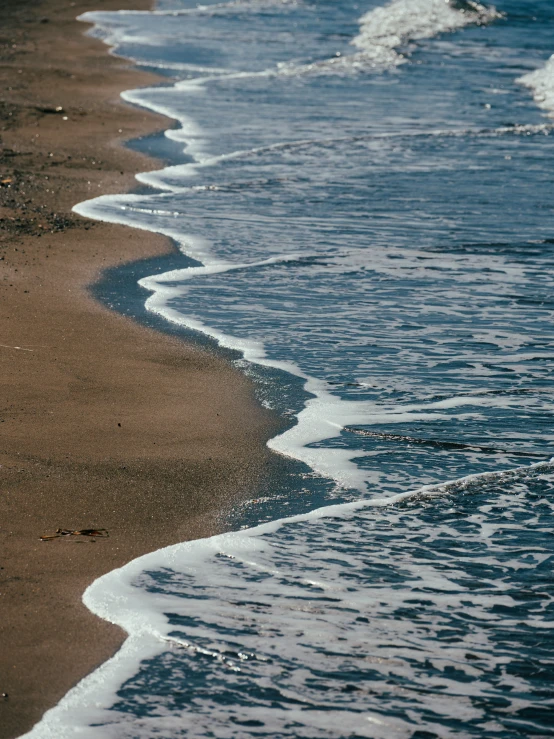 waves come in to the shore on a beach