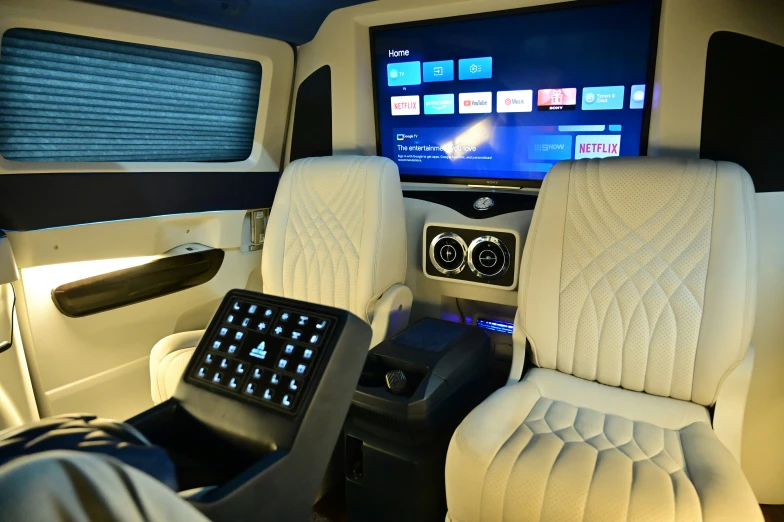 a white car's interior with the television on