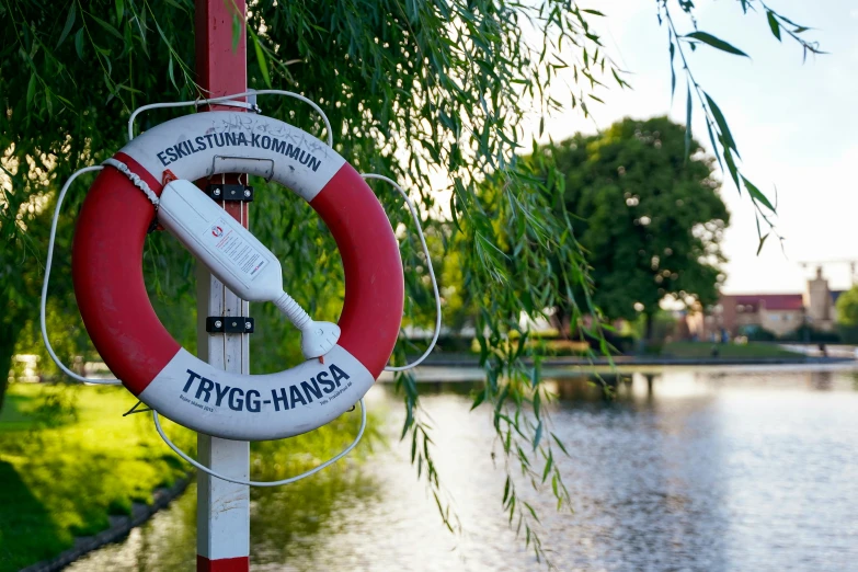 a sign that is on a pole by the water