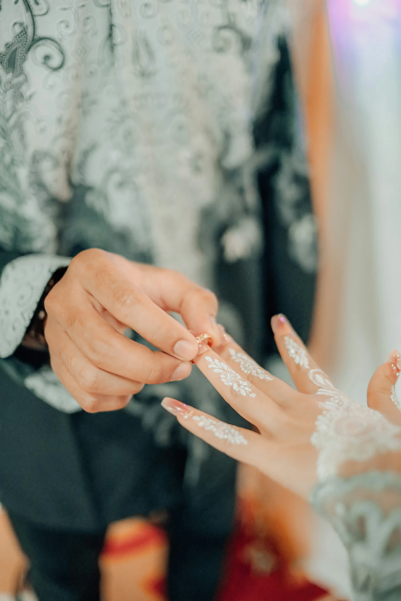 a bride holding on to a bride's finger