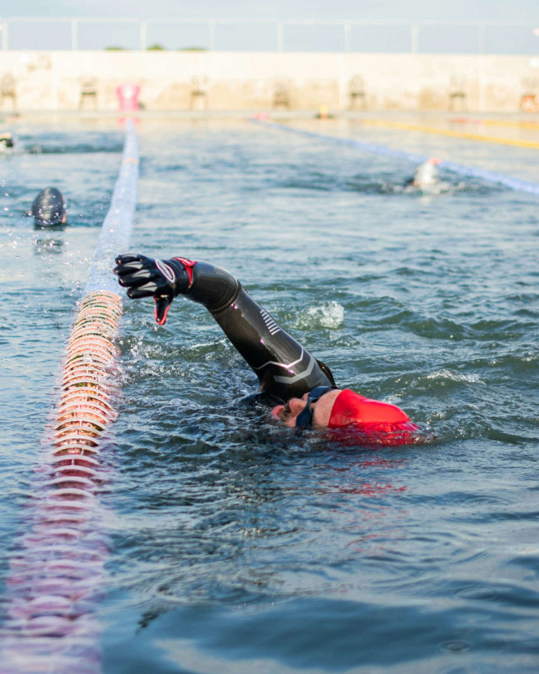 a woman swims in the water on a surfboard