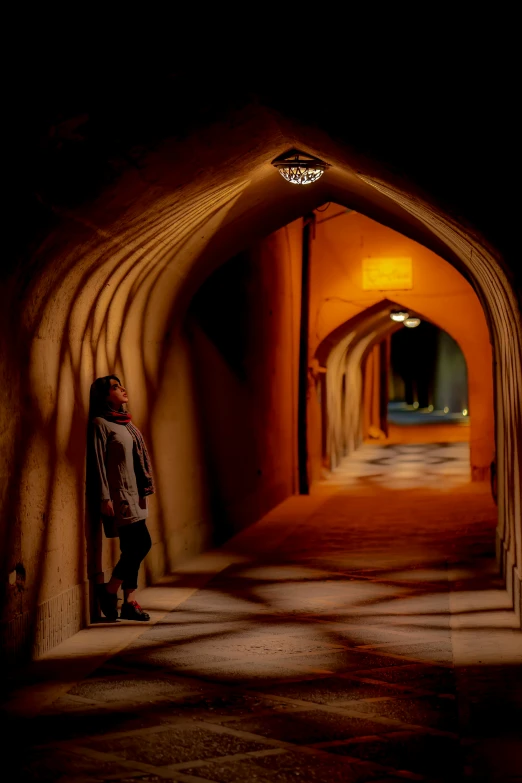 a man standing in an old archway in a tunnel