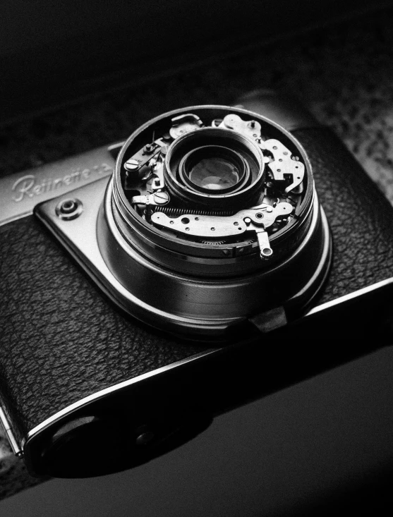 a black and white image of an old camera