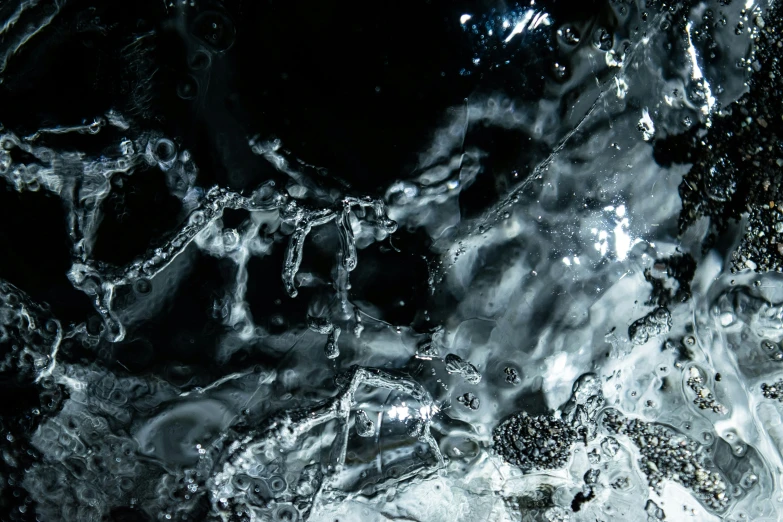 a mixture of grey and black liquid splattered on the surface