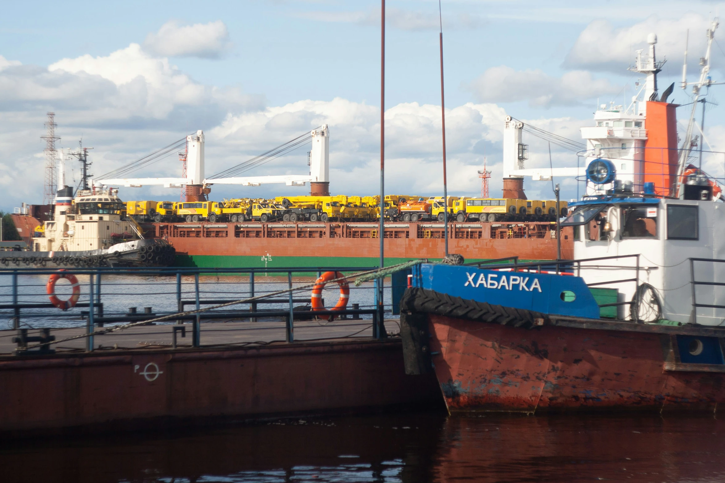 a big ship sitting at the docks in the middle of the day