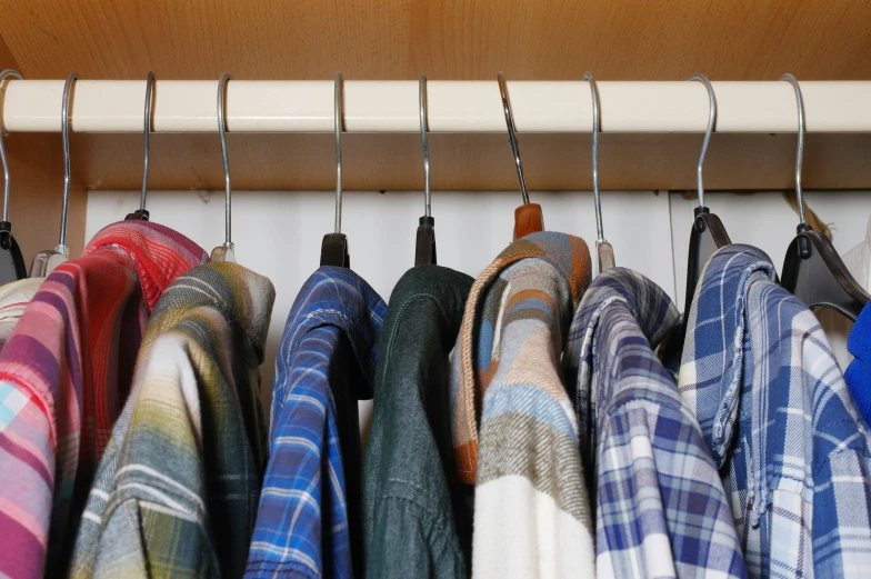 multiple coats hanging from a coat rack in a shop