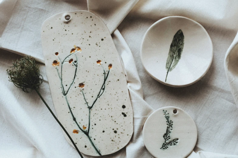 a plate with some leaves and other items that could be used as a decoration