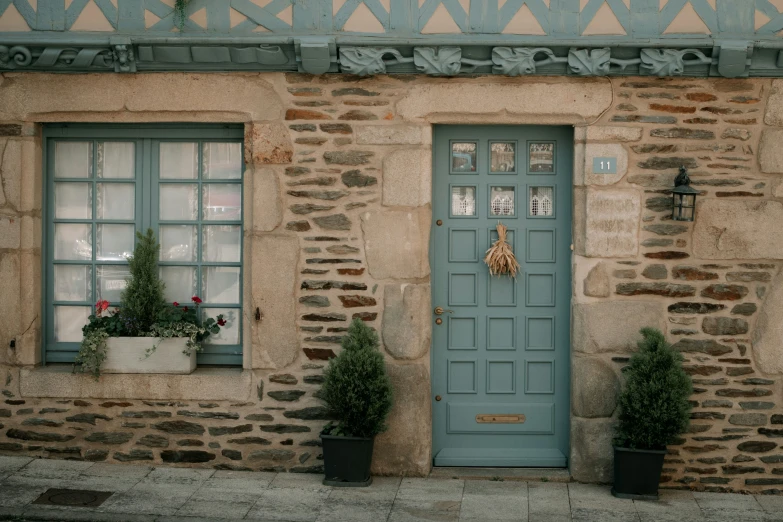 a blue front door sitting next to two windows