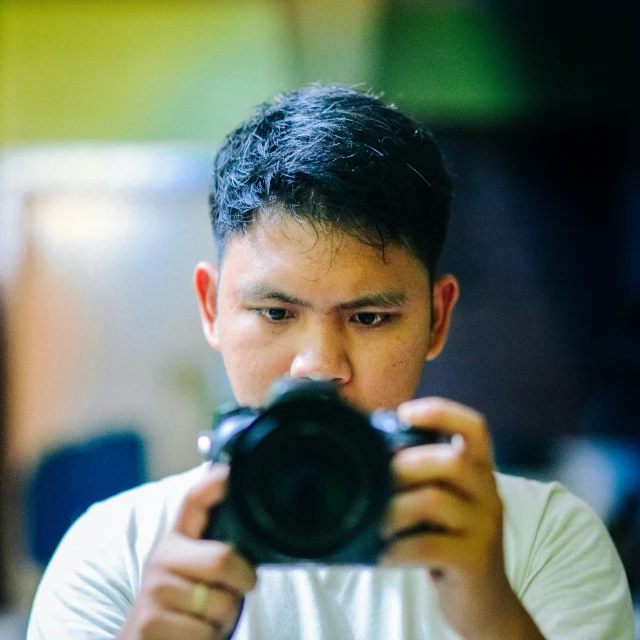 a young man taking a picture with a camera