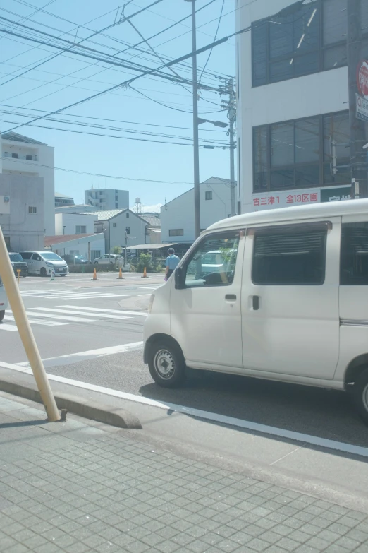 a van sitting in front of a tall building