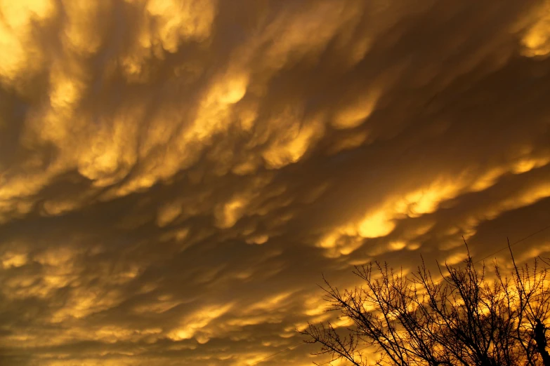 a few clouds that are yellow in the sky