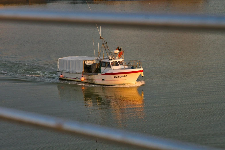 a small boat sailing on the water near other boats