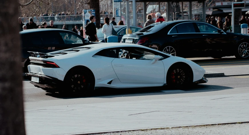 a white car is parked on the side of a street