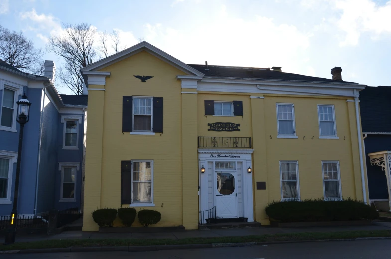 two buildings are colored yellow, with blue doors