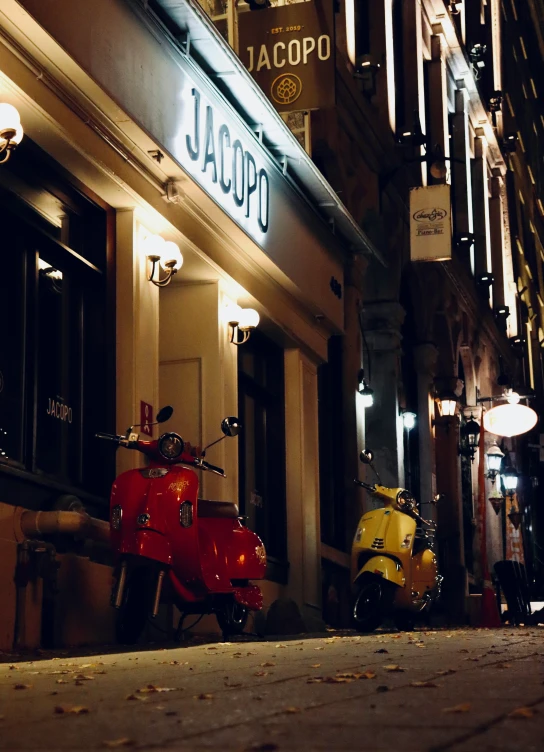 there is a red moped sitting outside of a bar