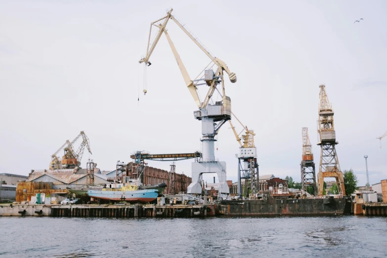 construction is underway on the water with crane in background