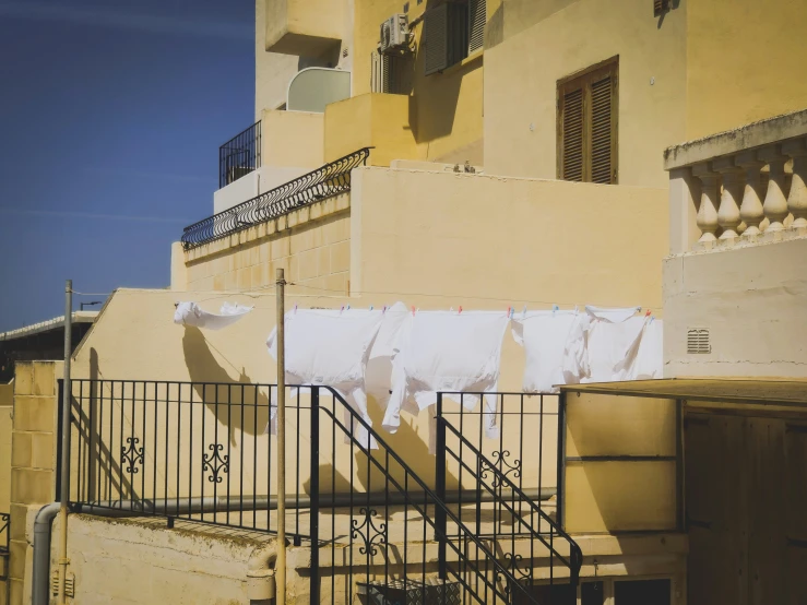 two clothes hanging on washing lines near building