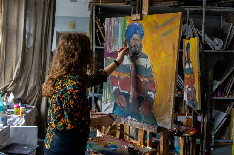 a woman who is painting a woman's portrait