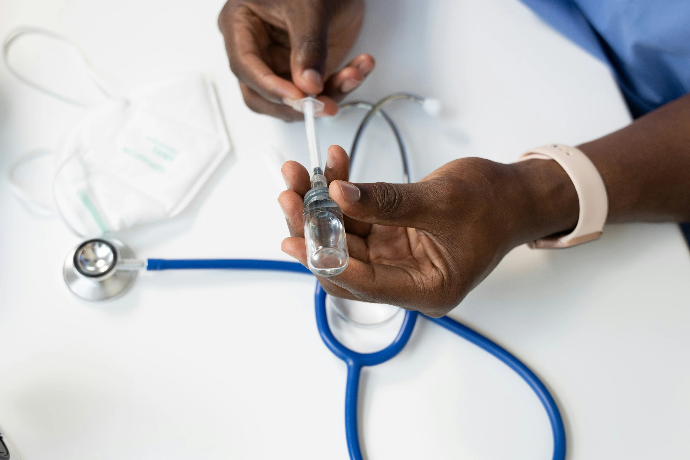 two doctors working on a computer connected to a doctor's stethoscope