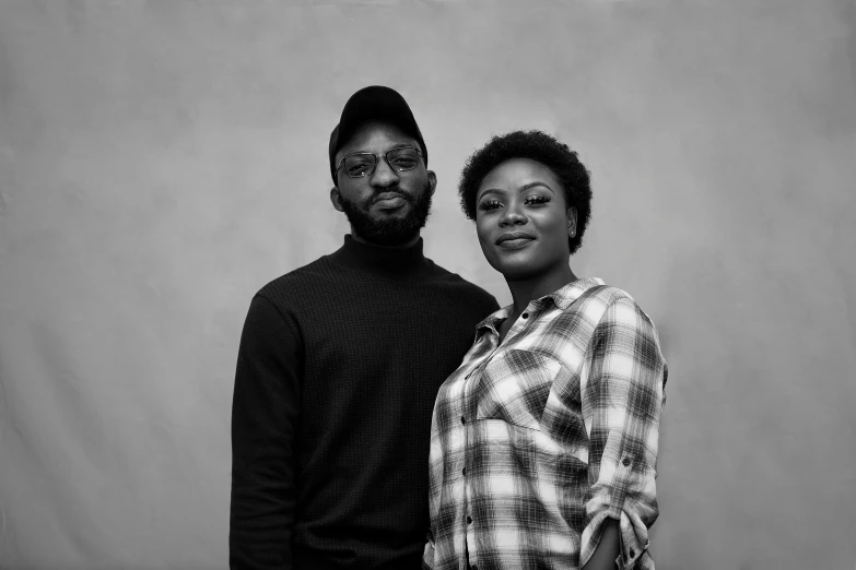 an older couple stands together in a studio