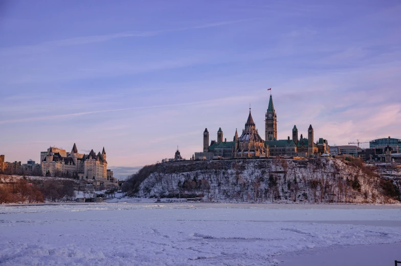 a large castle on top of a hill covered in snow