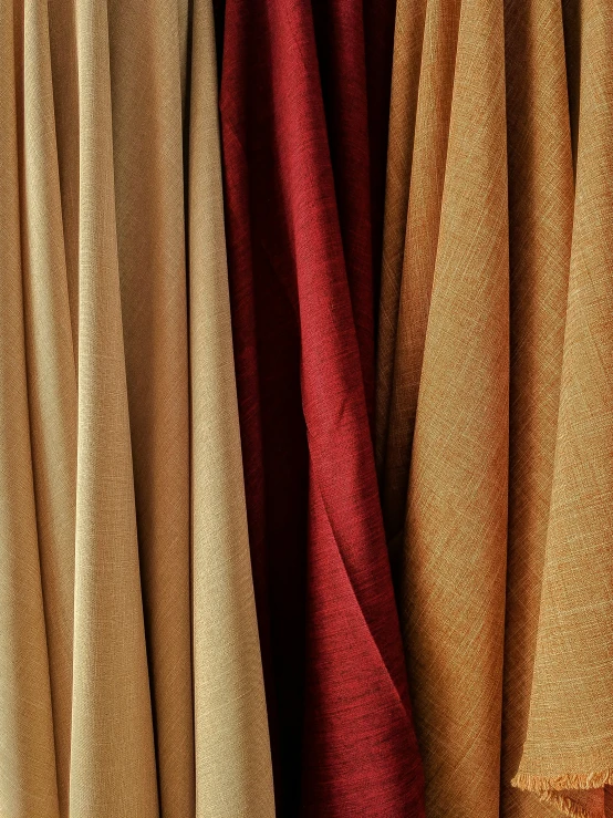 colorful curtains hanging in the sun on top of floor