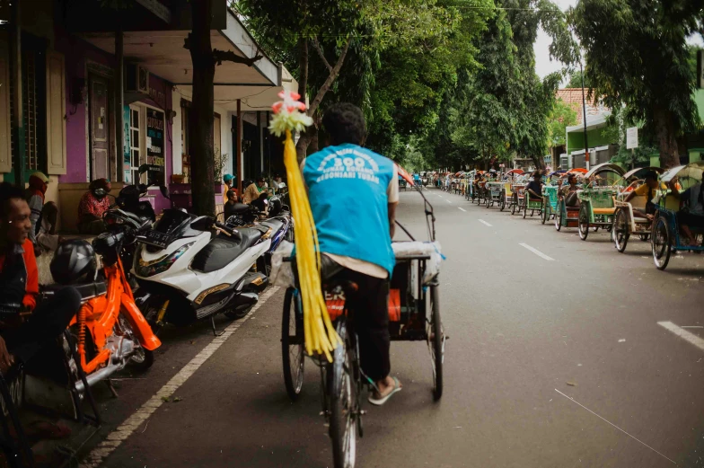 this is an image of people riding bicycles on the street